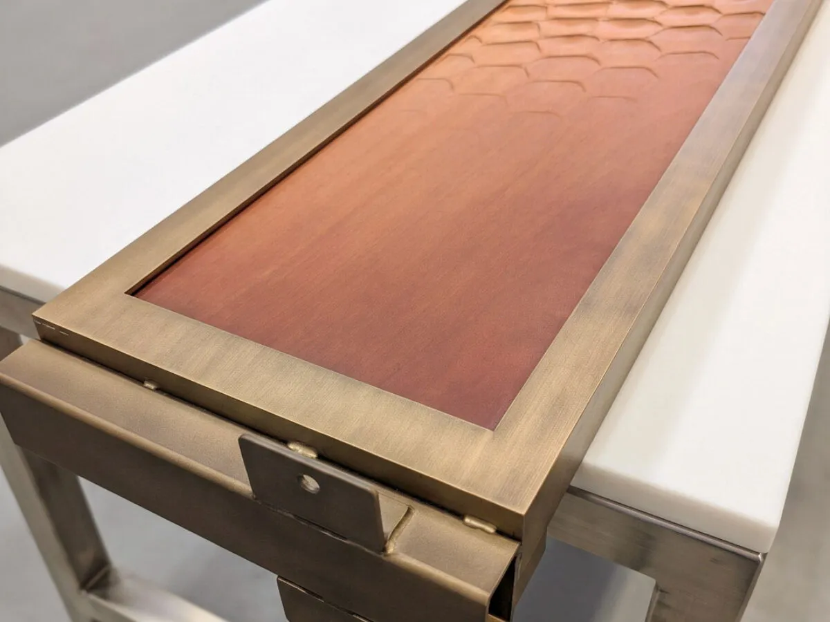 pannello porta con cornice OxyBrass e legno fresato a nido d'ape in lavorazione, porta d'ingresso su misura Metalbril